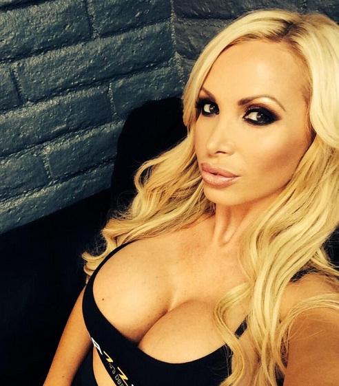 hot social media pic of Nikki Benz and her huge cleavage displayed in a black tank top