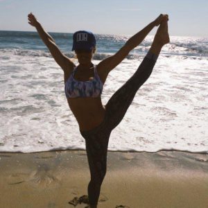sporty nicole aniston stretching on the beach