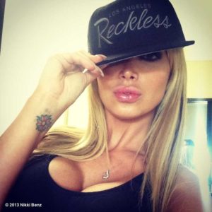 gorgeous pic of ukranian star nikki benz wearing a reckless hat and a tight black top showing off her tits